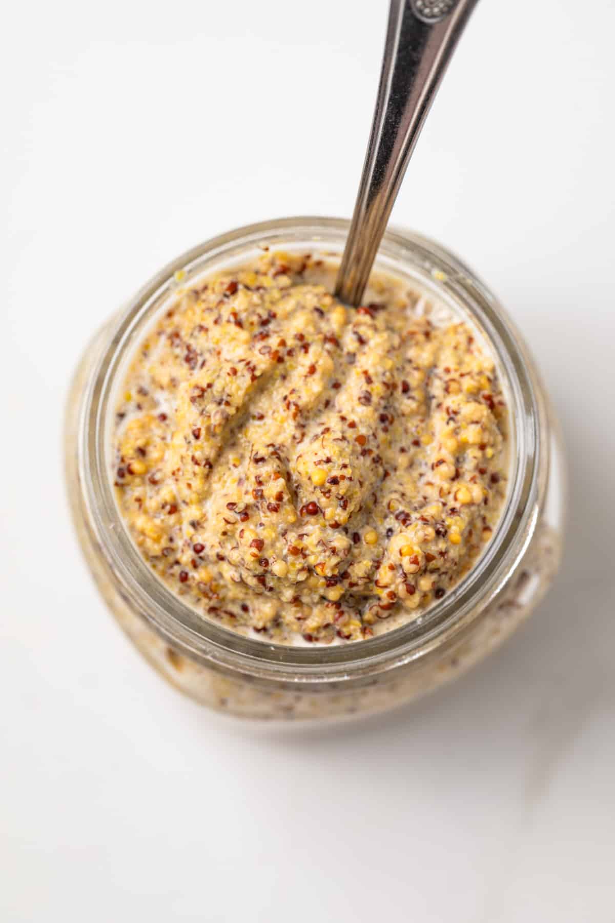 Homemade spicy mustard in a glass jar.