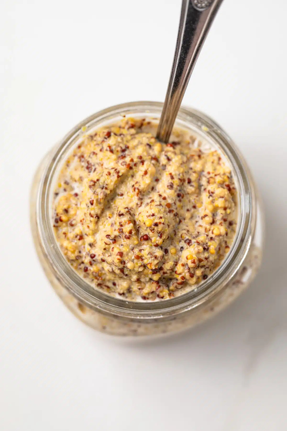 Homemade spicy mustard in a glass jar.