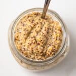 Homemade spicy mustard in a glass jar.