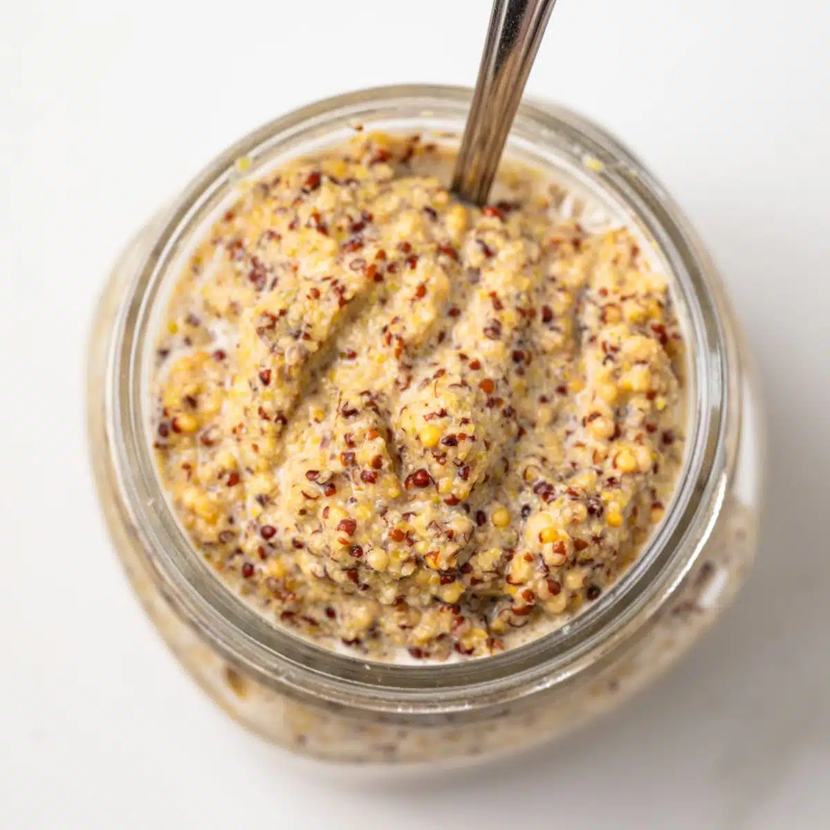 Homemade spicy mustard in a glass jar.
