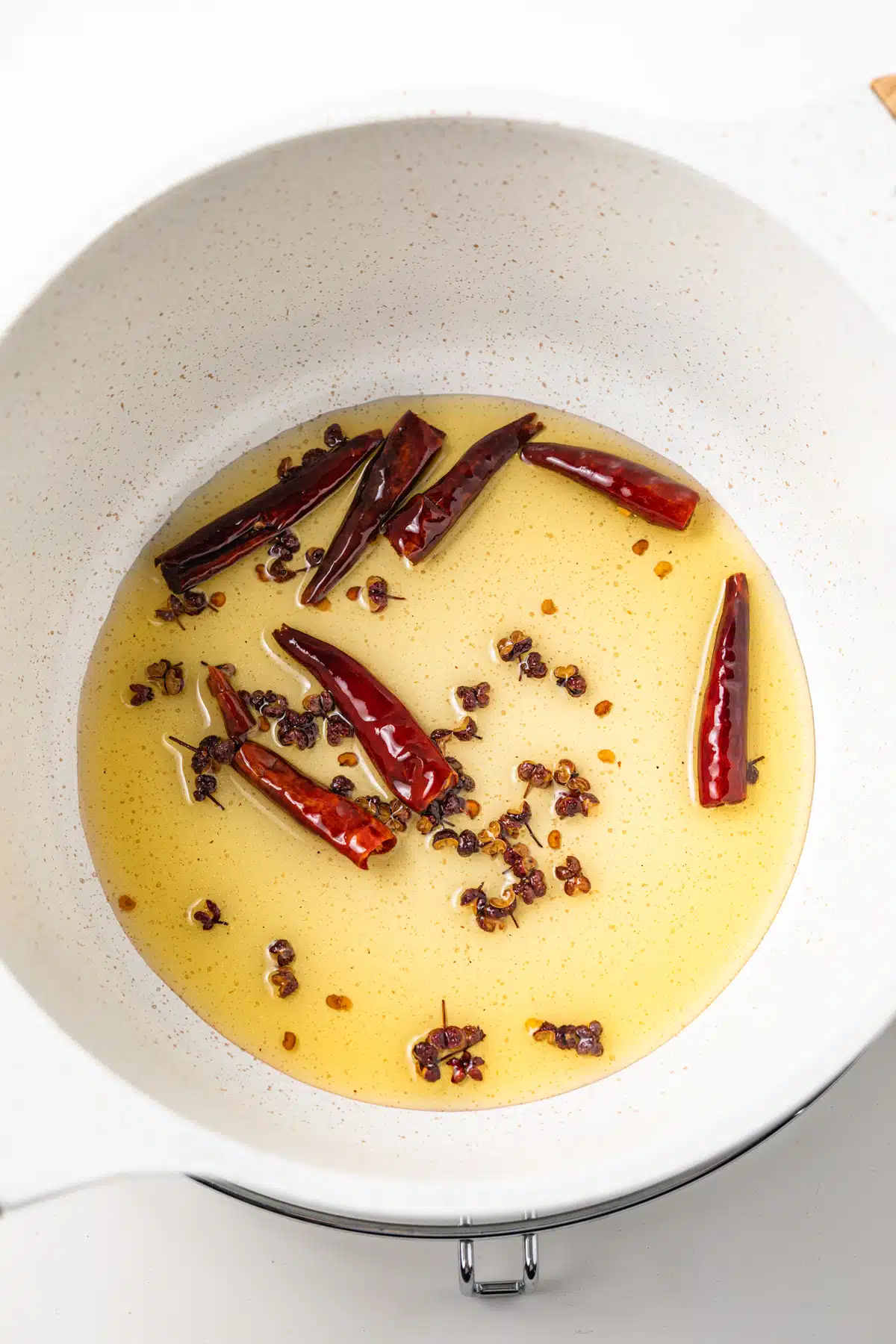 Dried chilies with peppercorns in oil.