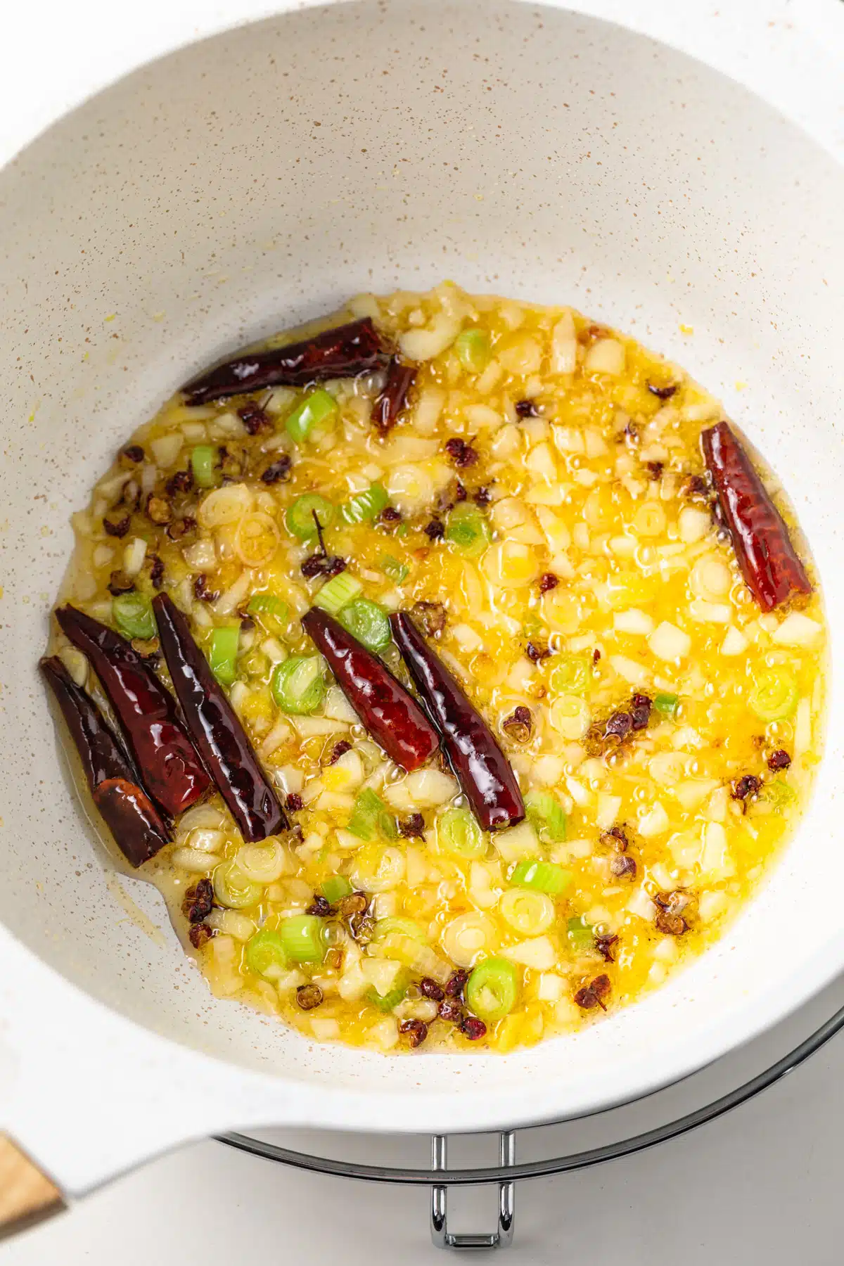 Sauteed garlic, scallions, ginger, peppercorns, and dried chilis.