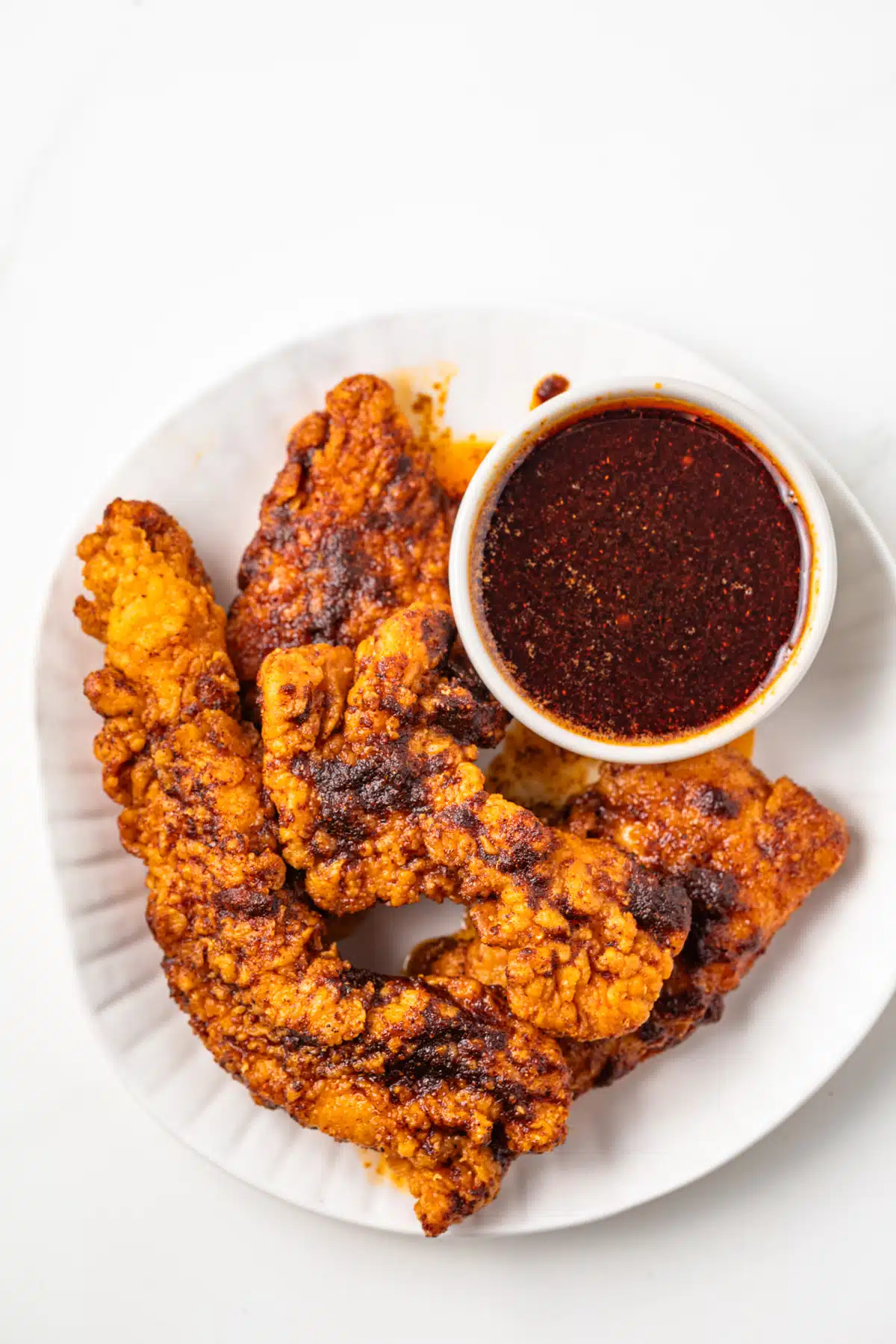 Chicken tenders with a side of Nashville hot sauce.