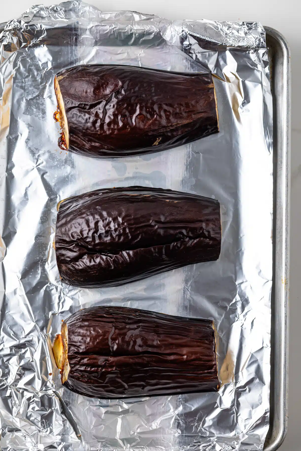 Roasted eggplant on a baking sheet.
