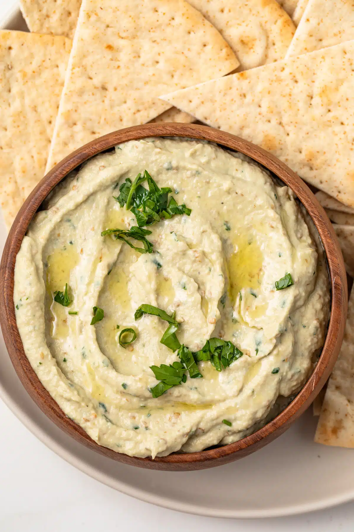 Overhead of baba ganoush in a wooden bowl.