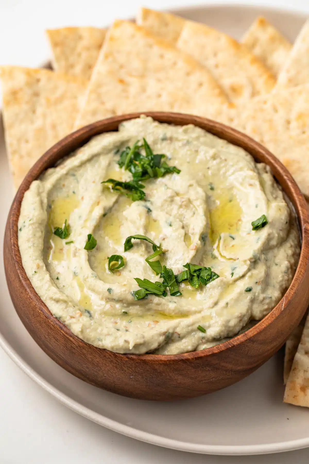 High angled view of baba ganoush in a wooden bowl.