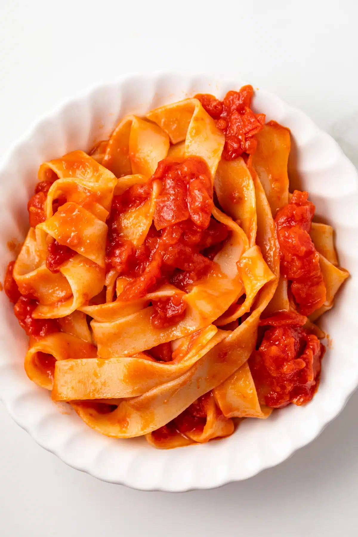 Overhead of butter roasted tomato sauce over pasta.