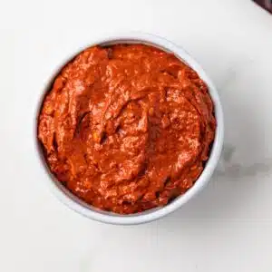 Overhead view of harissa paste in a white bowl.