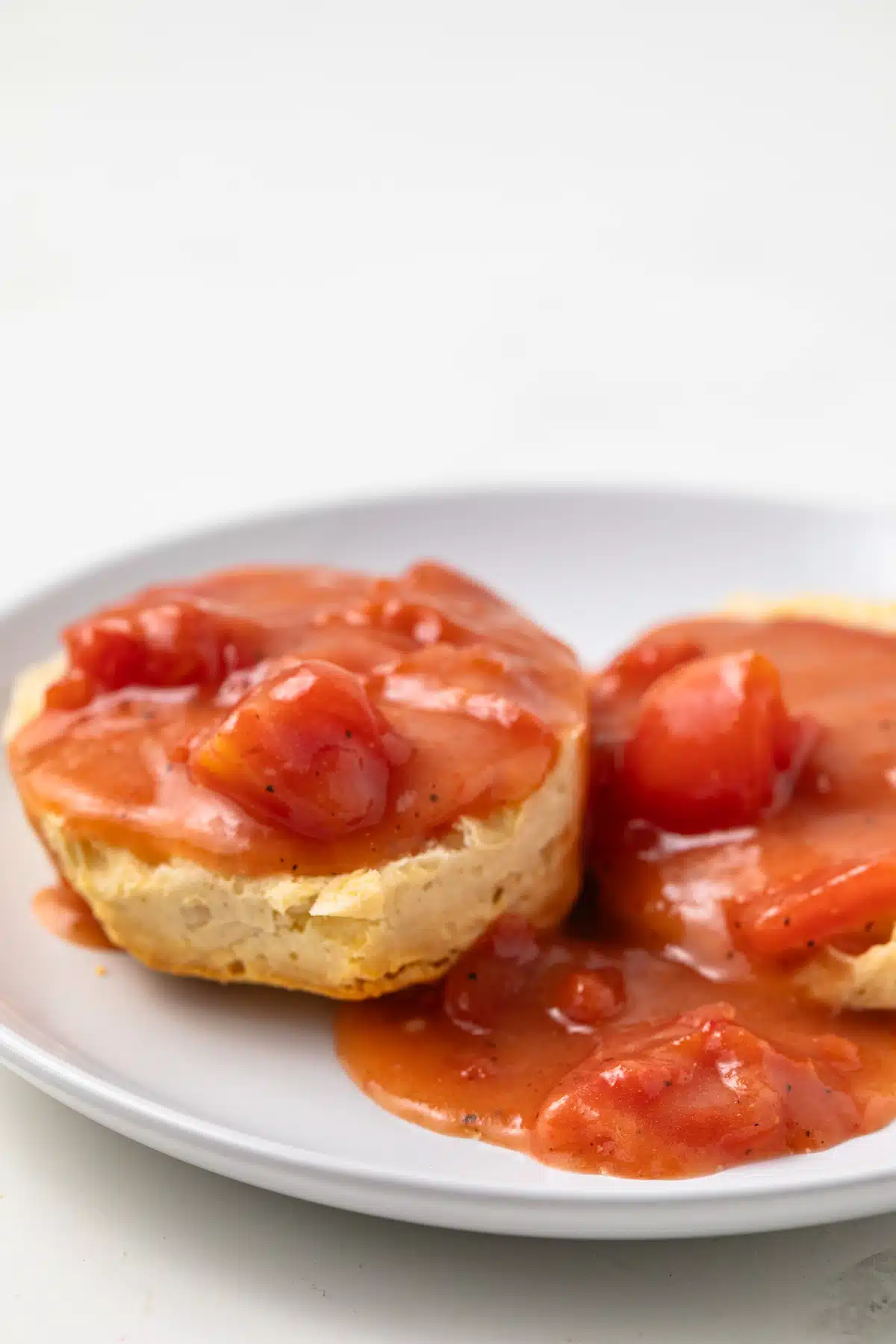 Side view of tomato gravy on a biscuit.