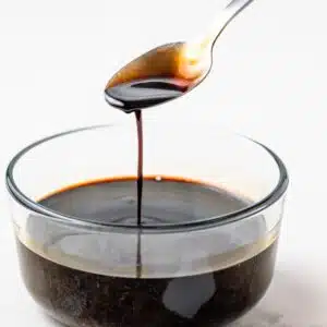 Balsamic glaze dripping off a spoon.