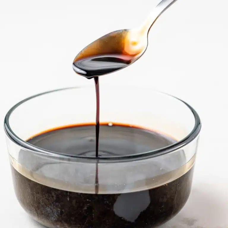 Balsamic glaze dripping off a spoon.