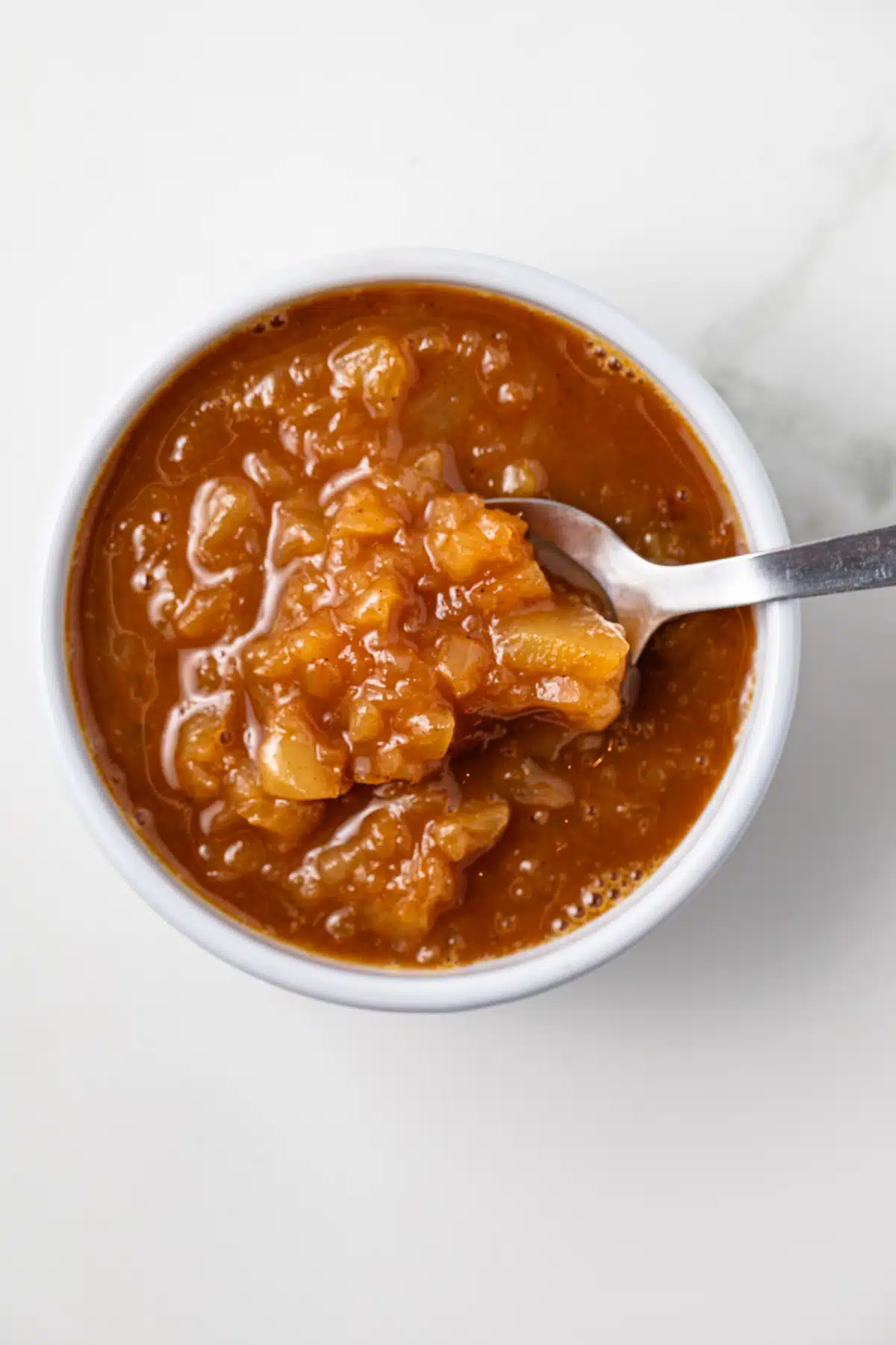 Pineapple glaze for ham in a white  bowl.