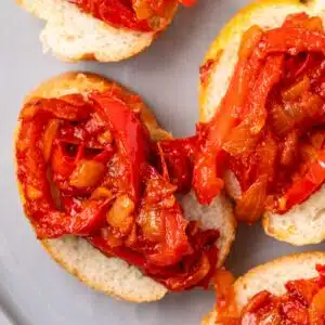 Overhead of peperonata on bread slices.