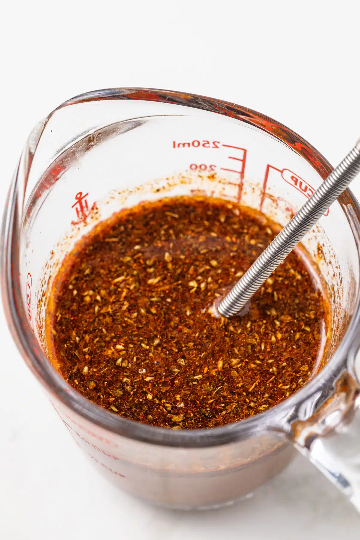 Homemade fajita sauce in a glass measuring cup.
