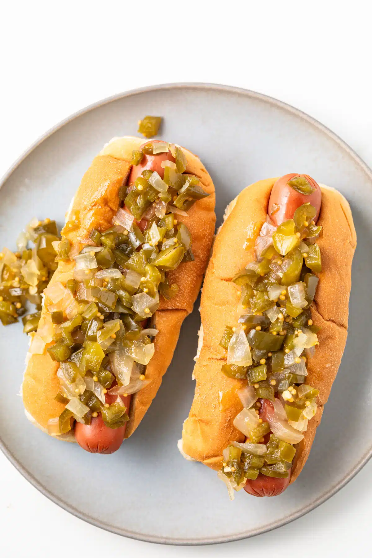 Two hot dogs with hot pepper relish.