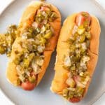 Two hot dogs with hot pepper relish.