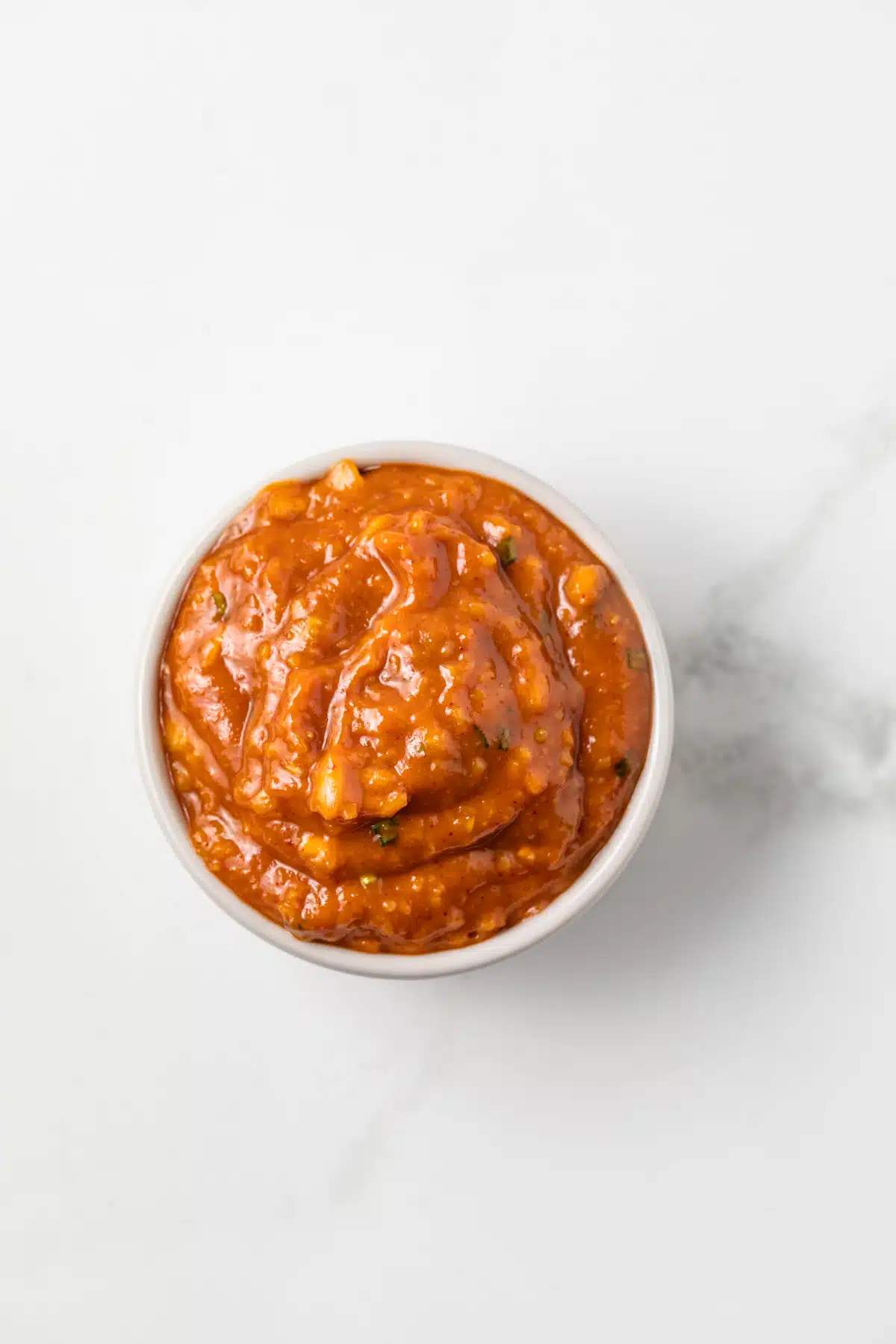 Overhead view of ssamjang in a small bowl.