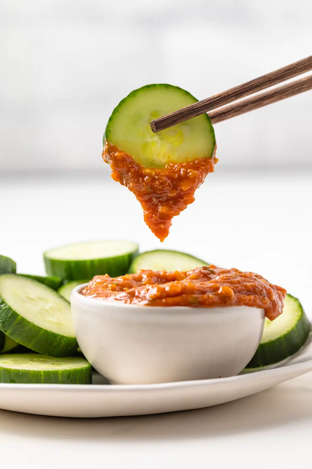 A cucumber slice dipped in ssamjang.