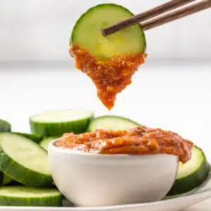 A cucumber slice dipped in ssamjang.