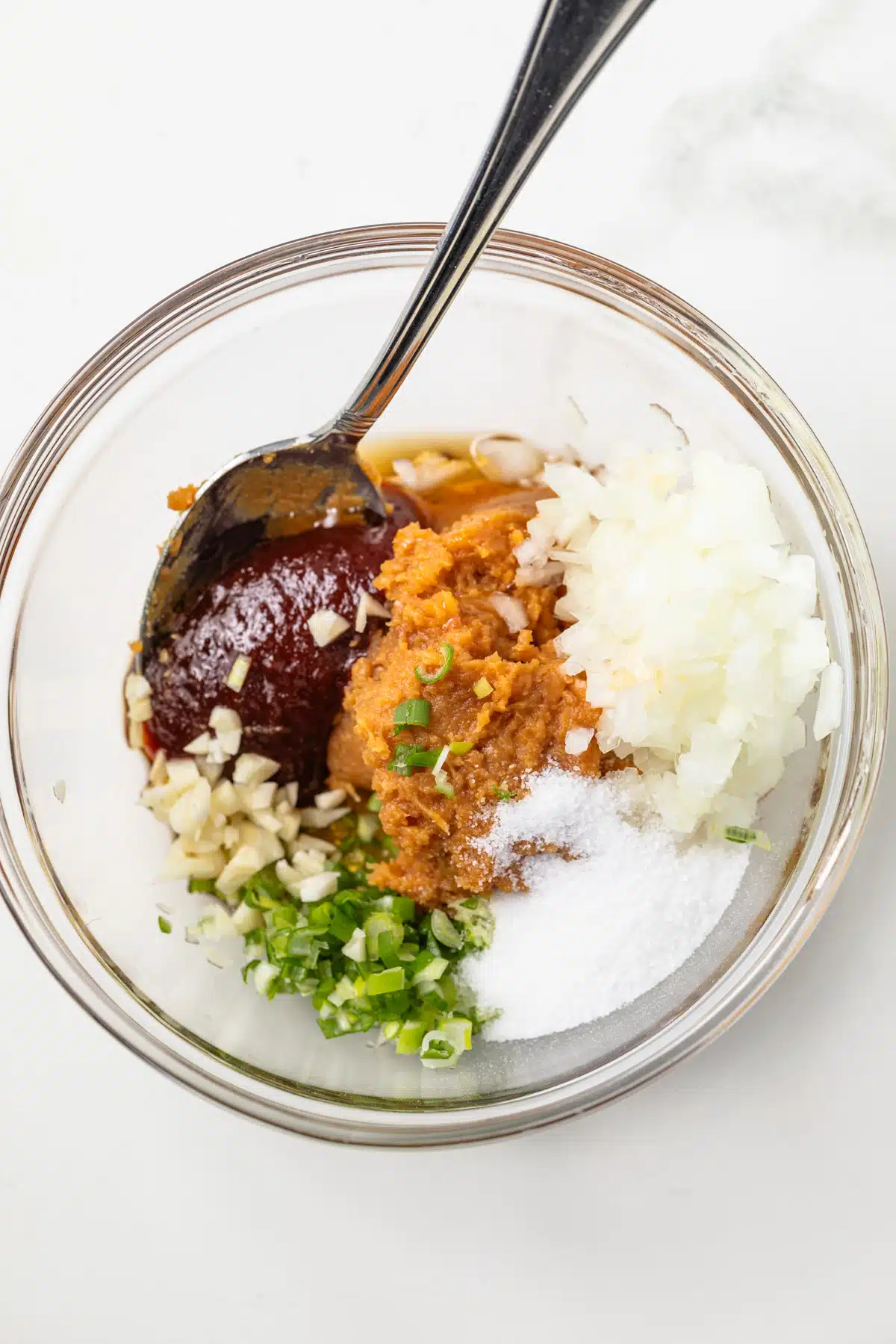 Ingredients for ssamjang in a glass bowl.