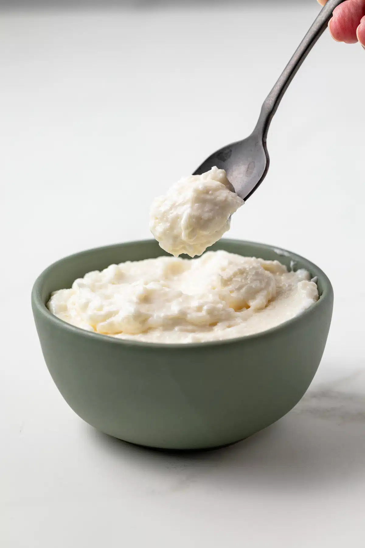 Toum in a bowl with a spoon.