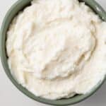 Lebanese garlic sauce in a green bowl.