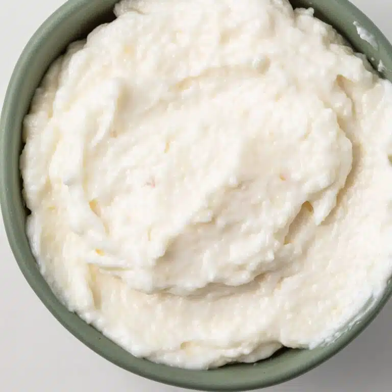 Lebanese garlic sauce in a green bowl.