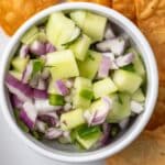 Overhead view of cucumber jalapeno salsa in a white bowl.