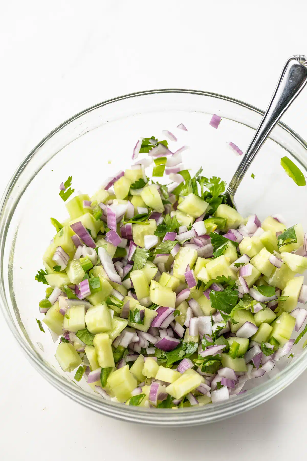 Cucumber jalapeno salsa in a glass bowl.
