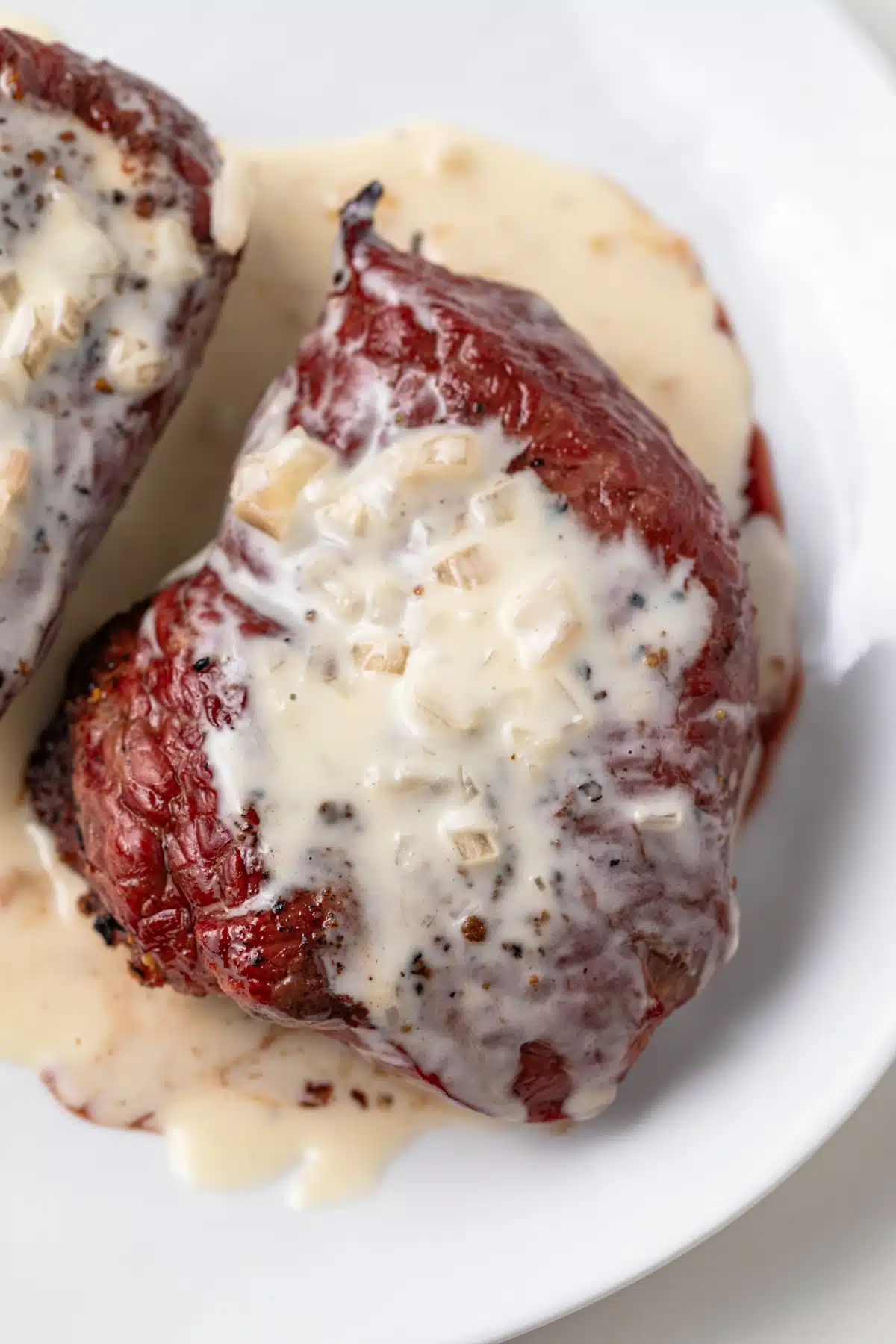 Close up of sherry cream sauce over sirloin steak.