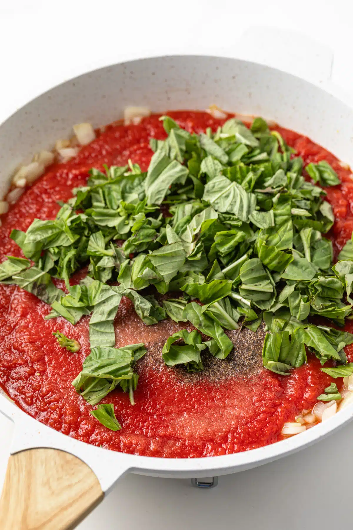 Tomato sauce with basil in a saucepan.