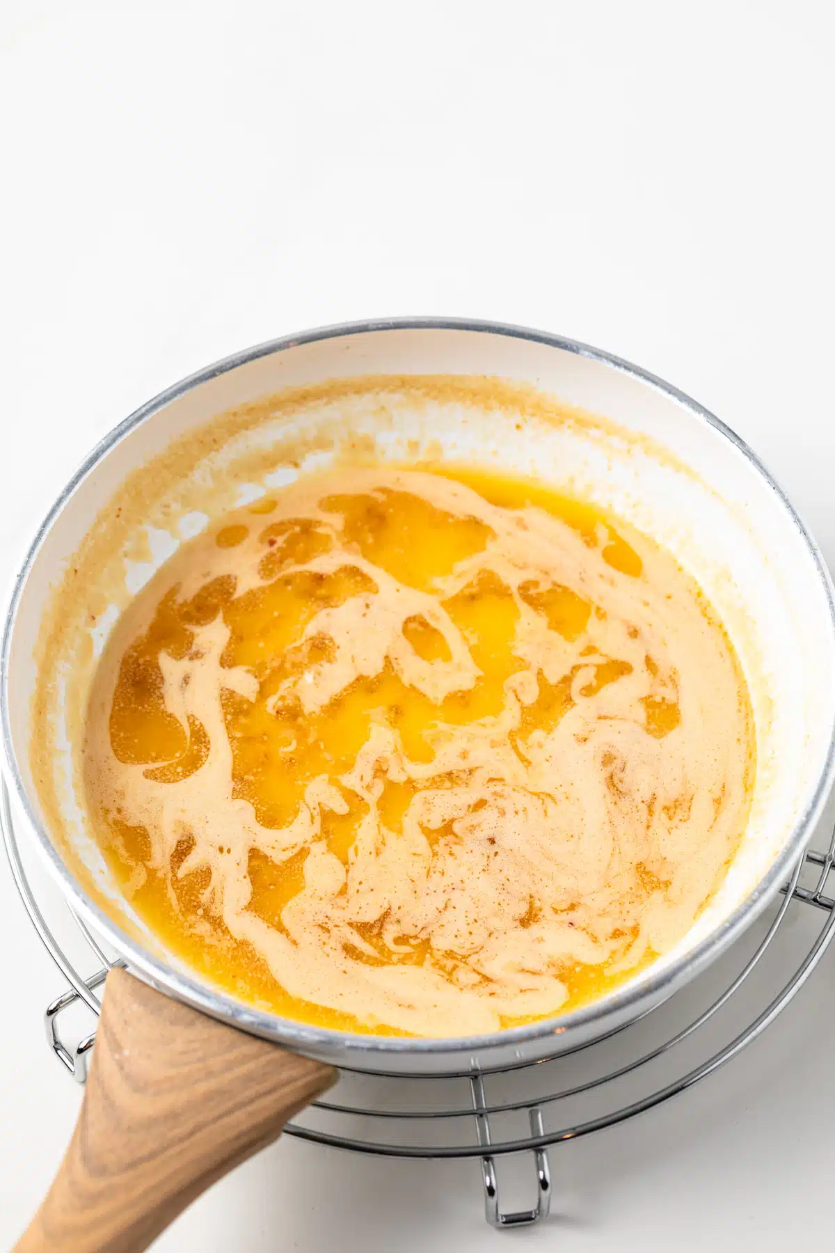Scampi sauce for shrimp in a skillet.