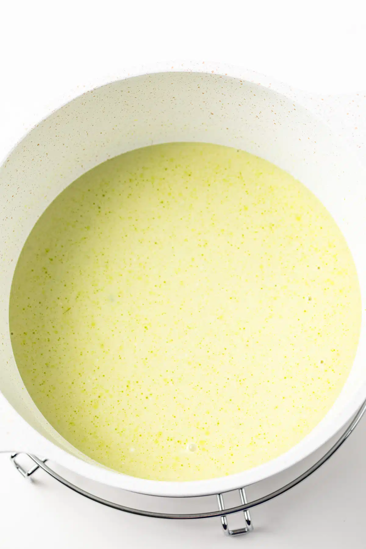 Green curry base in a saucepan.