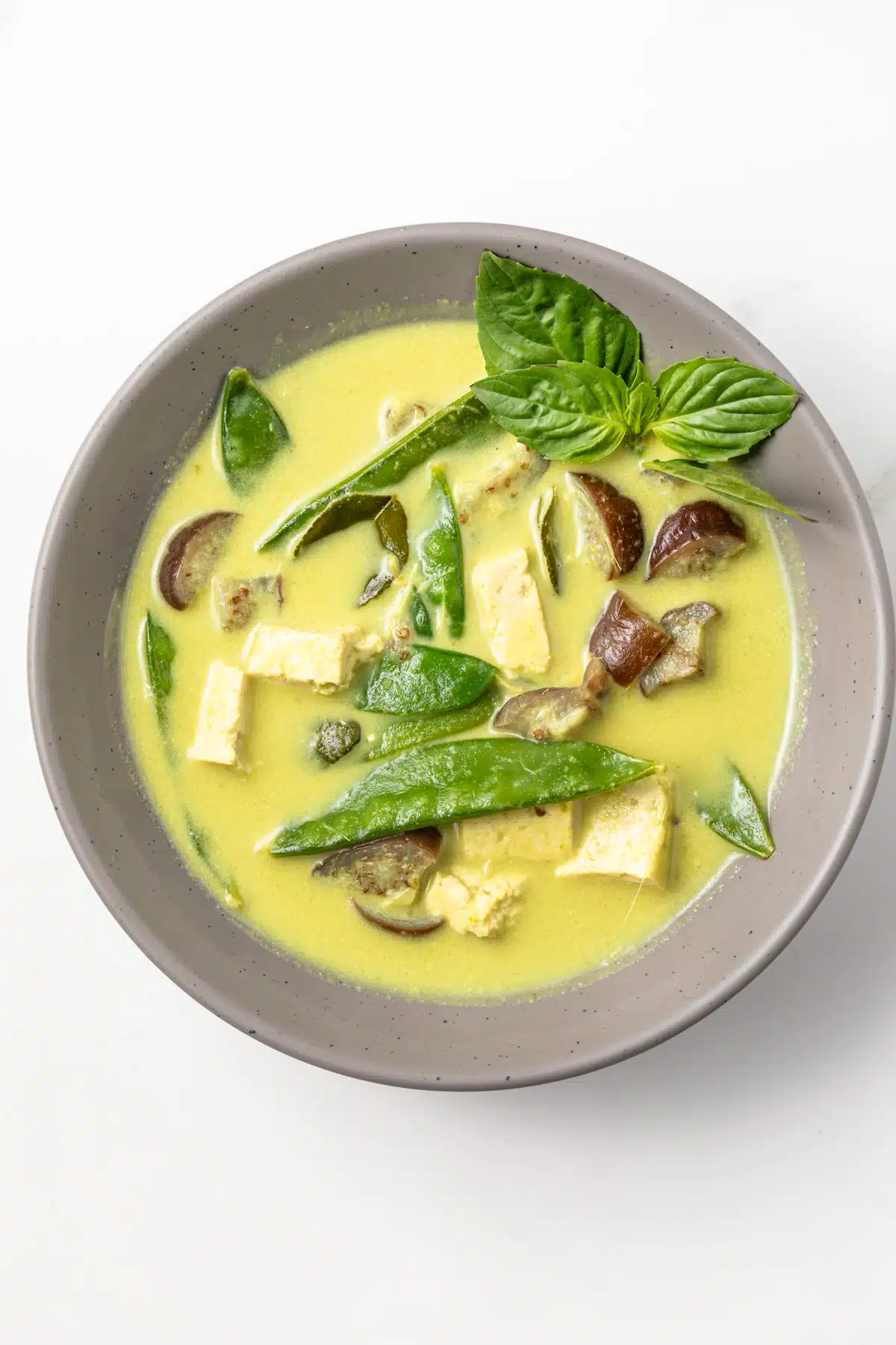Thai green curry in a gray bowl.