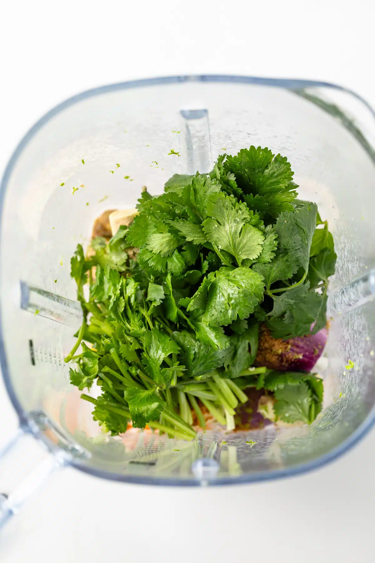 Ingredients for green curry paste in a blender.